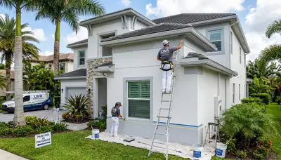 Professional house painters working on exterior home repaint in Bradenton FL