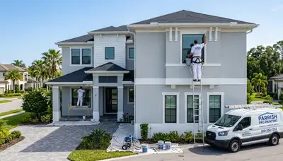 Professional house painters working on exterior home in Bradenton FL