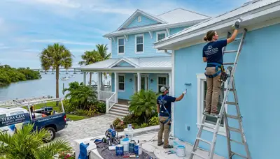Professional house painters working on exterior home in Bradenton, FL