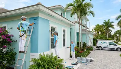 Professional house painters working on exterior home repaint in Bradenton, FL